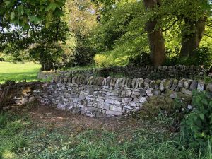 Dry stone wall repaired.