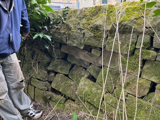 Damaged dry stone wall needs repair